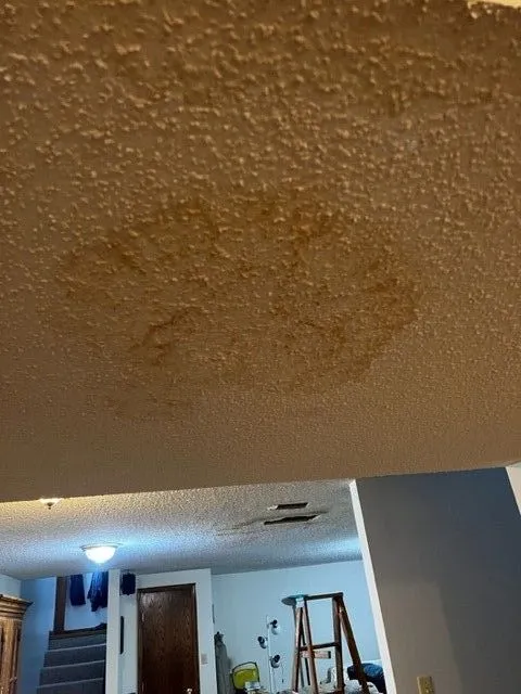 Water damage stain on textured ceiling