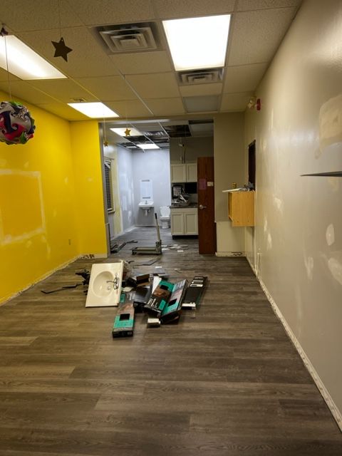 Hallway and bathroom area mid-installation at the day care