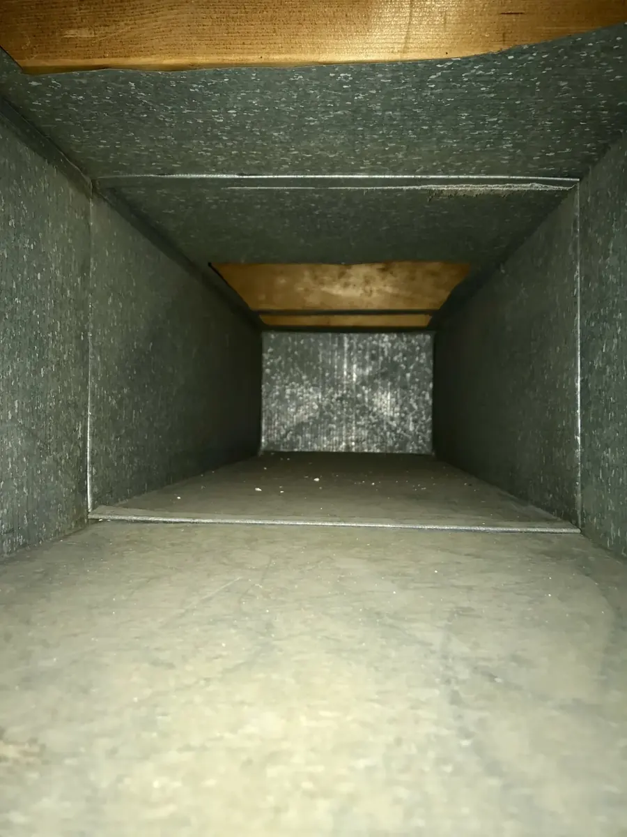 Inside of the same home air duct after Vortex cleaning, restored to bare clean metal