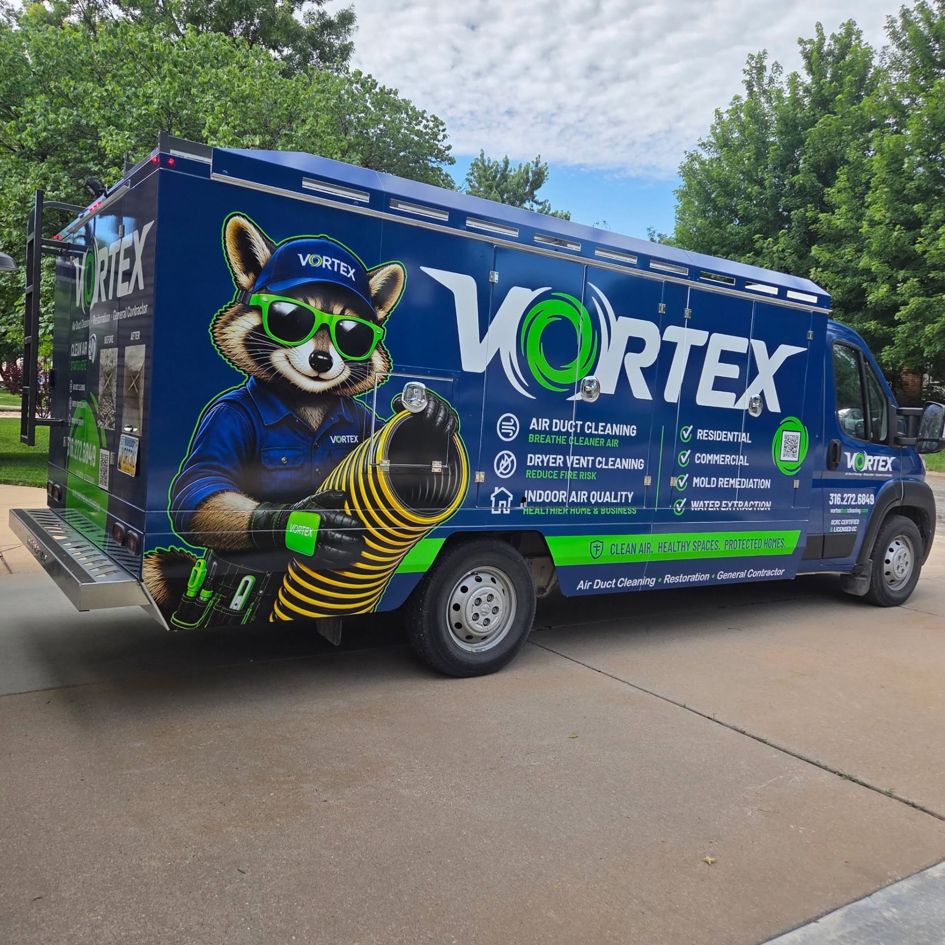 Truck-mounted air duct cleaning vacuum unit connected to a Wichita, Kansas home HVAC system