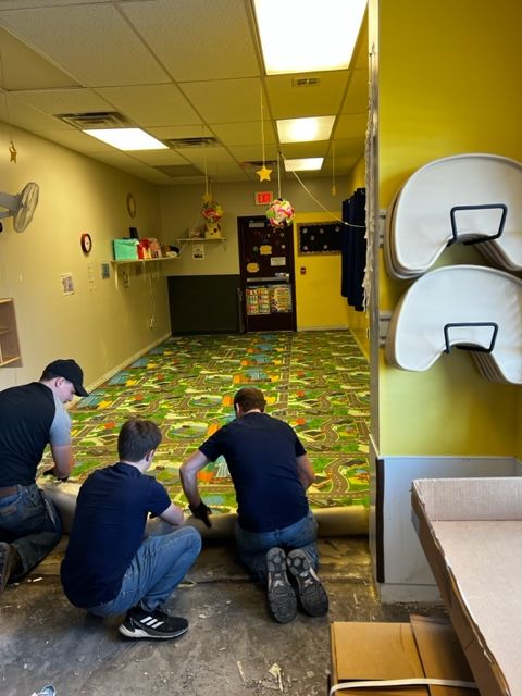 Installing new luxury vinyl plank flooring at the Derby day care