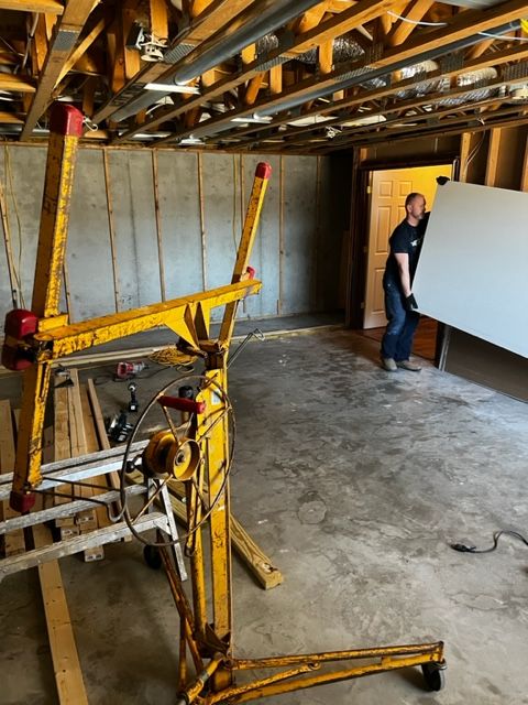 Hanging new drywall in a Wichita basement remodel